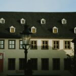 A tall building with windows and a street light in front of it