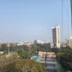 a view of a tennis court in a city