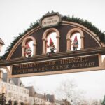 Charming Christmas market entrance with festive decorations and elf sculptures in Cologne, Germany.