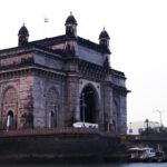 a large building sitting next to a body of water