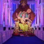 gold hindu deity statue on purple couch