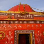 a red and yellow building with a sign on top of it