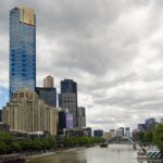 A river running through a city next to tall buildings