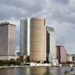 Modern cityscape with tall buildings by the water.