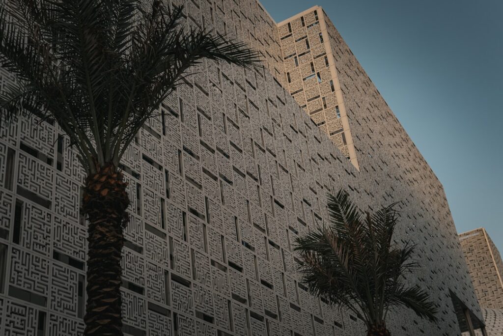 a tall building with a palm tree in front of it