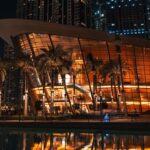 Modern building with palm trees at night