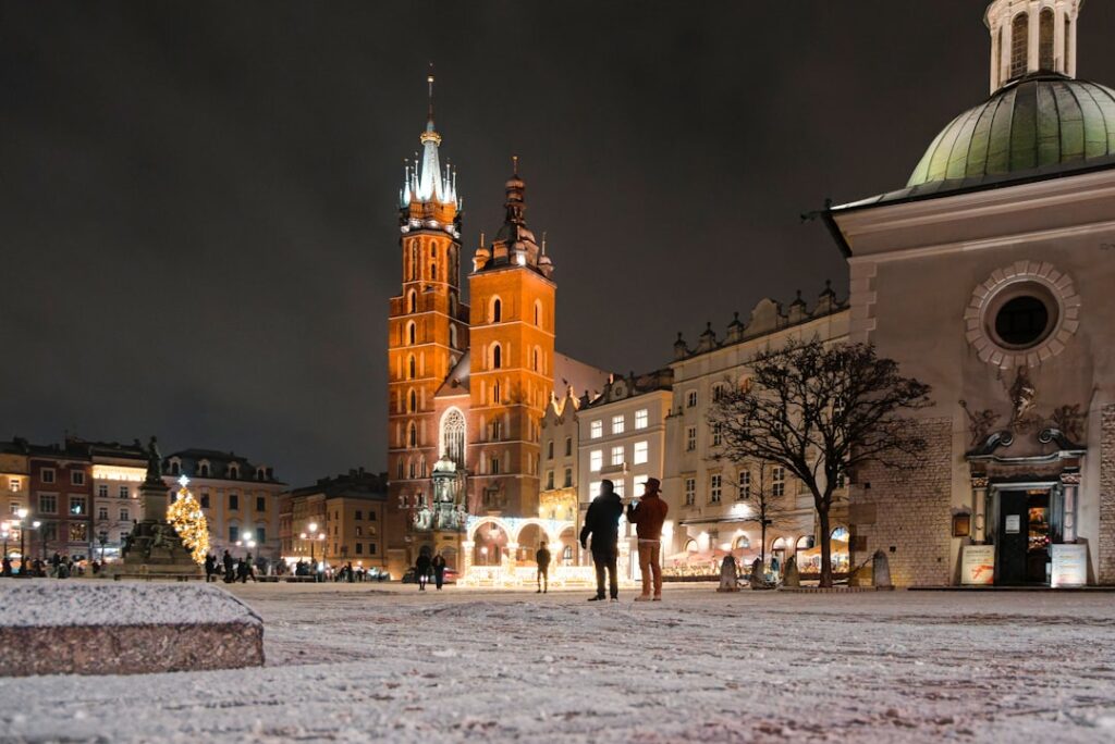 Historic square with illuminated church at night