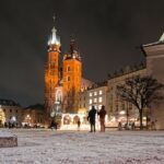 Historic square with illuminated church at night
