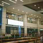 brown wooden table near white wall