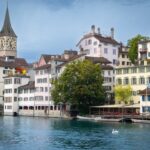 a group of buildings next to a body of water
