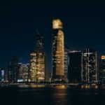 Stunning night view of Abu Dhabi's illuminated skyline reflecting on the water.
