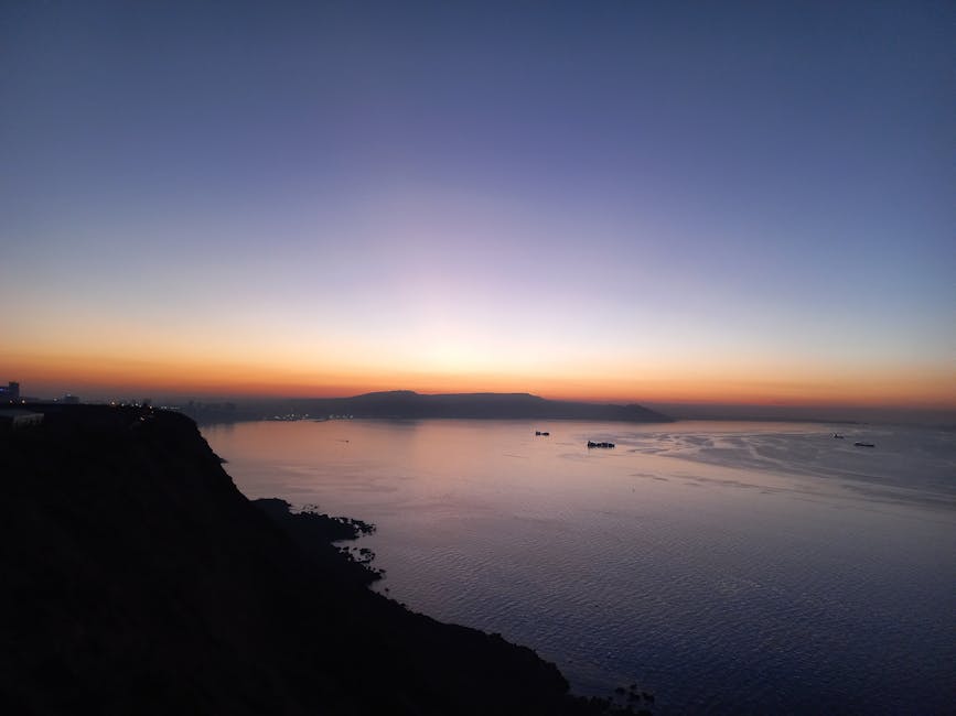Captivating sunset over the Oran coast with silhouettes of ships and a dramatic horizon.