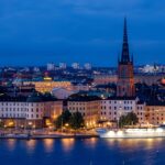 city, cityscape, waterfront, illuminated, ship, architecture, skyline, historic center, church, steeple, water, sea, night, evening, twilight, nature, lights, mirroring, stockholm, sweden, scandinavia