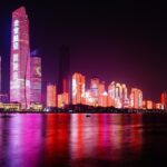 City skyline illuminated with colorful lights at night