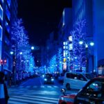 a city street at night with blue christmas lights