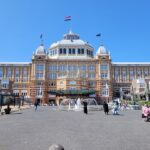 a large building with a fountain in front of it