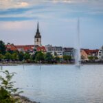A large body of water with a clock tower in the background