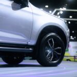 A white suv is on display at a show