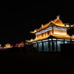 a building lit up at night with lights on it