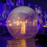 a large white ball floating on top of a body of water